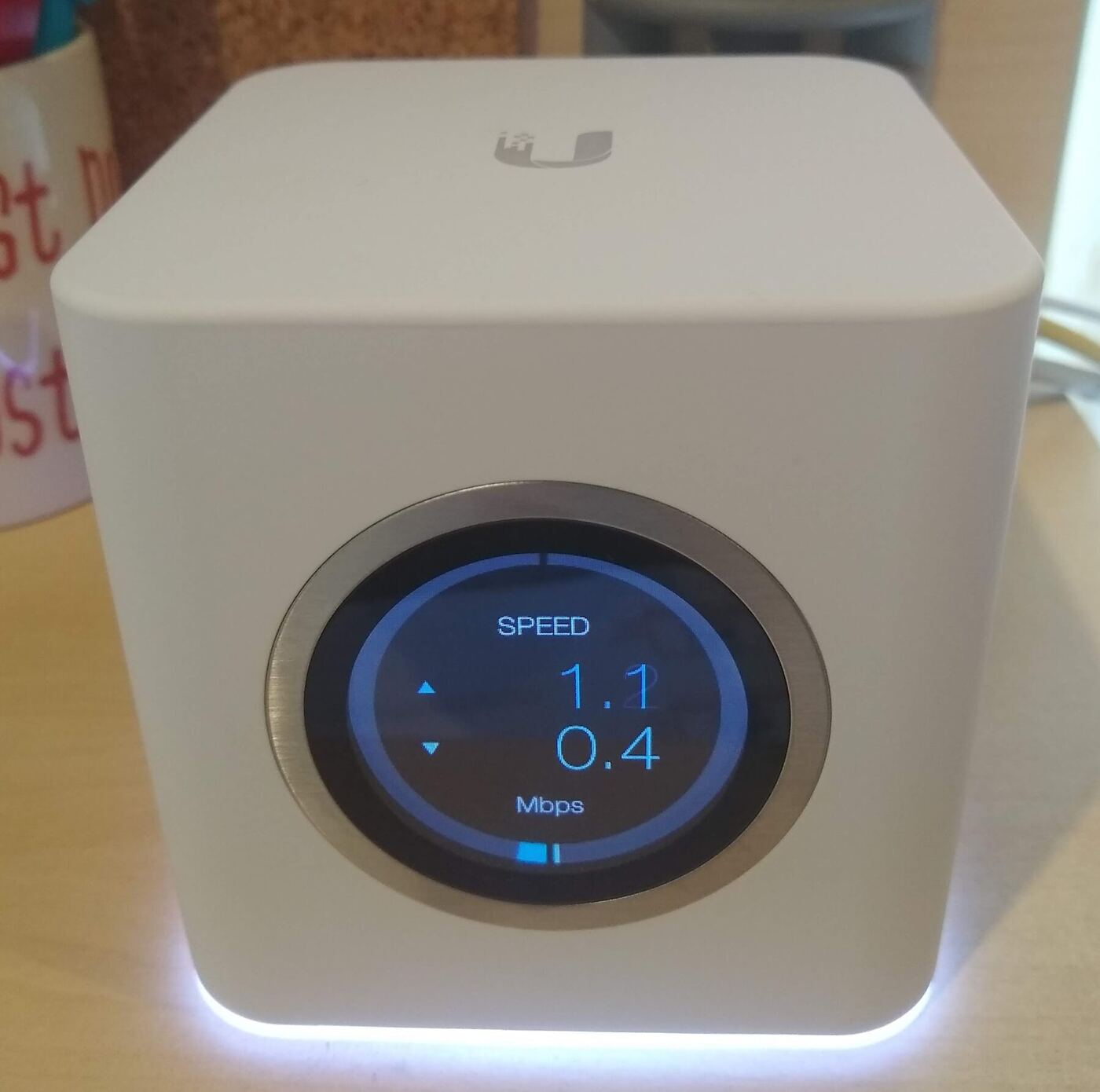 A mesh WiFi system router unit on a desk