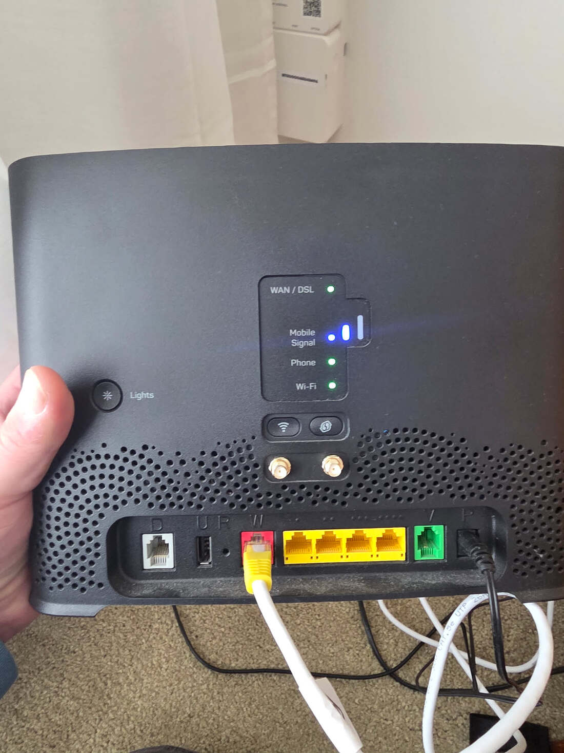 The rear of a modem showing a Mobile Signal indicator alongside WAN/DSL, Phone and Wi-Fi lights
